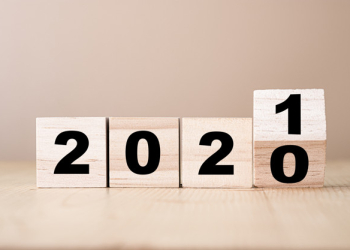 Hand flipping wooden blocks for change year  2020 to 2021 . New year and holiday concept.